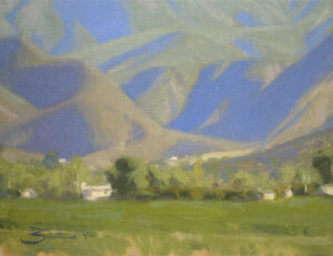 Ojai Mountain Shadows, giclee print by Dan Schultz. Large mountains with blue and violet shadows rise behind a green foreground.
