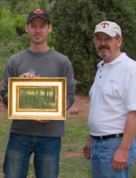 Dan Schultz receives first place award for his "Light through the Trees" painting from award judge Skip Whitcomb at the Glen Eyrie Plein Air Paint Out in Colorado Springs, Colorado.