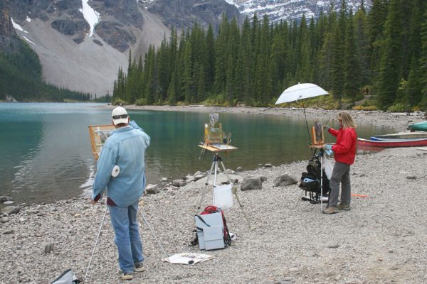 Hermann Brandt and Liz Wiltzen painting with Dan Schultz at Moraine Lake in Banff National Park, Canada