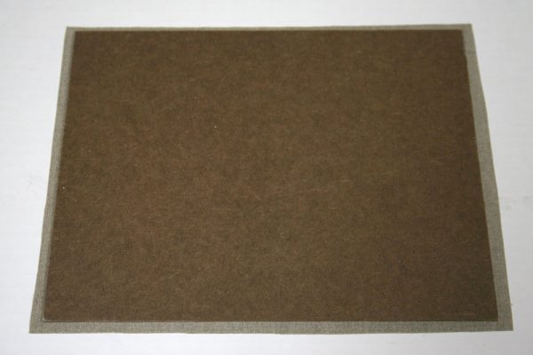 Hardboard white side down on a piece of linen with an extra 1/4″ of linen on each side.
