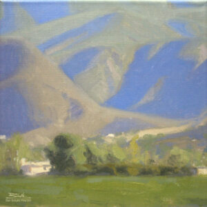 Ojai Mountain Shadows, giclee print by Dan Schultz. Large mountains with blue and violet shadows rise behind a green foreground.