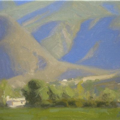 Ojai Mountain Shadows, giclee print by Dan Schultz. Large mountains with blue and violet shadows rise behind a green foreground.
