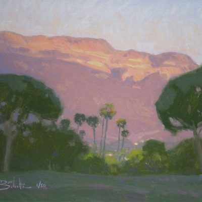 Ojai Pink Moment, giclee print by Dan Schultz. Pink sunset light on Topa Topa Bluff in the Ojai Valley, with Palm trees and other trees in the foreground.