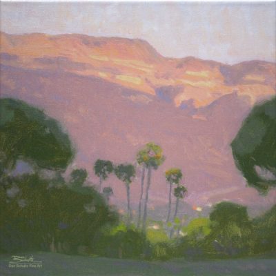 Ojai Pink Moment, giclee print by Dan Schultz. Pink sunset light on Topa Topa Bluff in the Ojai Valley, with Palm trees and other trees in the foreground.