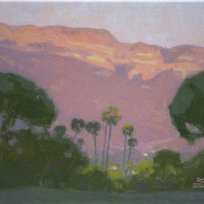 Ojai Pink Moment, giclee print by Dan Schultz. Pink sunset light on Topa Topa Bluff in the Ojai Valley, with Palm trees and other trees in the foreground.