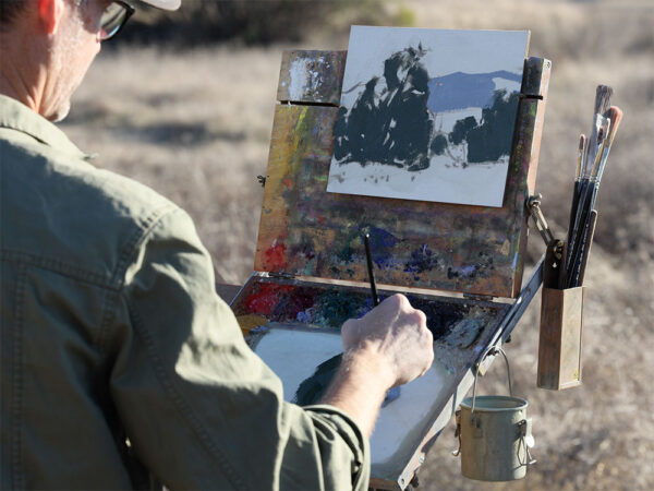 Dan Schultz working on a landscape painting outdoors
